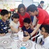 HKRI Care and Share Volunteers and Children Try their Hand at Making Traditional Snacks